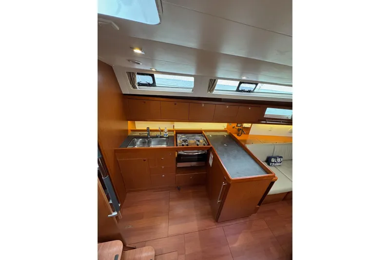  Yacht Photos Pics Interior of 2017 Beneteau Oceanis 45 yacht, featuring a modern kitchen and seating area.