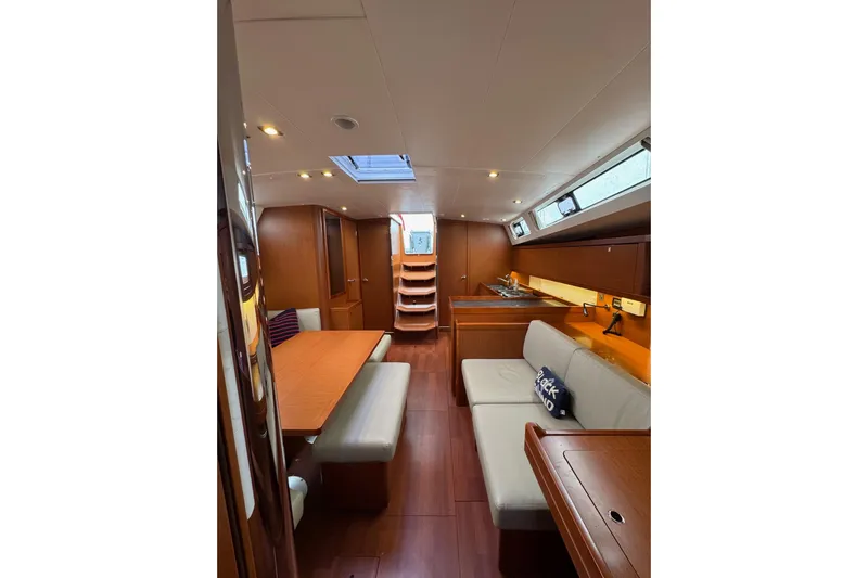  Yacht Photos Pics Interior of 2017 Beneteau Oceanis 45 yacht, featuring elegant wood finishes and modern seating.