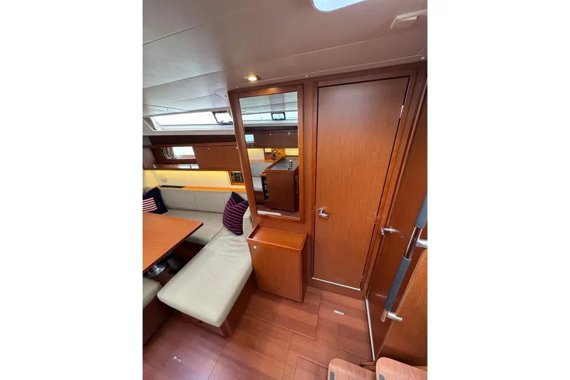  Yacht Photos Pics Interior of 2017 Beneteau Oceanis 45 yacht with wood finish and seating area.