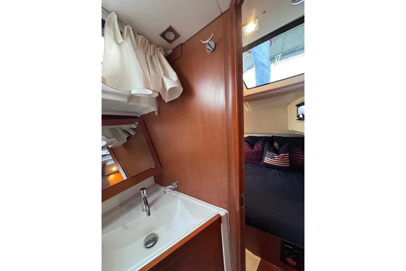 Yacht Photos Pics Interior of 2017 Beneteau Oceanis 45 yacht showing bathroom sink and cozy cabin.