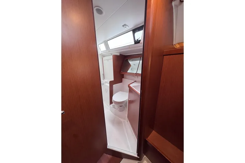  Yacht Photos Pics Interior view of 2017 Beneteau Oceanis 45 yacht bathroom with wooden finish.