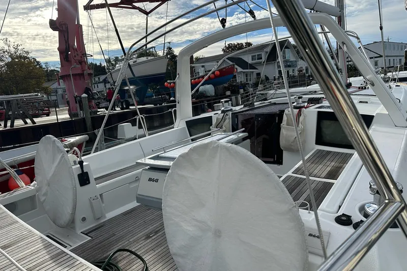  Yacht Photos Pics 2017 Beneteau Oceanis 45 sailboat docked, featuring dual steering wheels and modern navigation equipment.