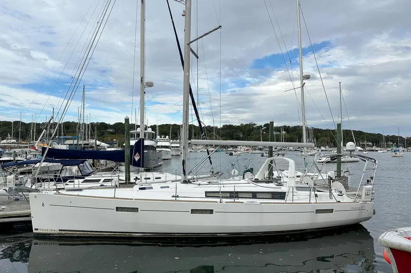  Yacht Photos Pics 2017 Beneteau Oceanis 45 sailboat docked in a marina under cloudy skies.