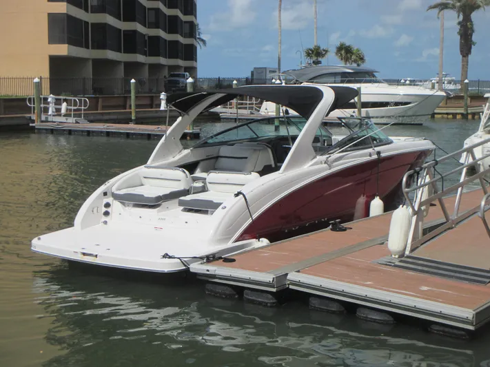  Yacht Photos Pics 2017 Regal 3200 Bowrider docked at marina, featuring sleek design and spacious seating.