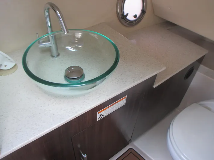  Yacht Photos Pics Luxurious bathroom in 2017 Regal 3200 Bowrider with glass sink and modern fixtures.