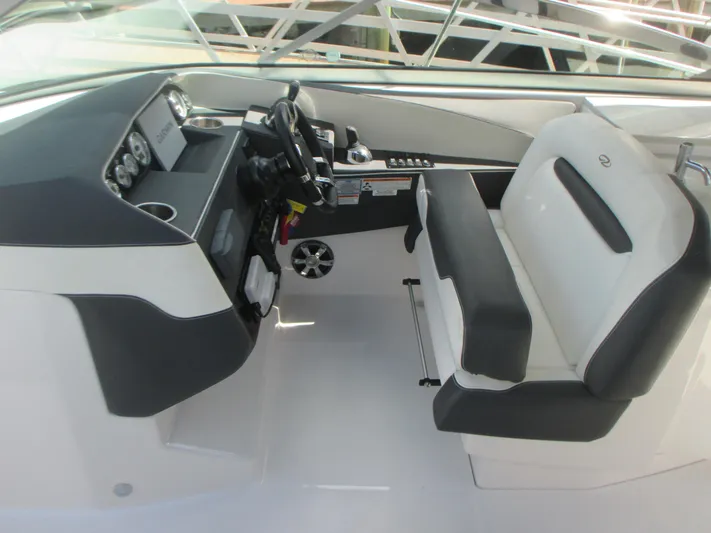  Yacht Photos Pics 2017 Regal 3200 Bowrider cockpit with steering wheel and seating.