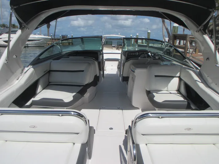  Yacht Photos Pics 2017 Regal 3200 Bowrider interior with spacious seating and sleek design at a marina.