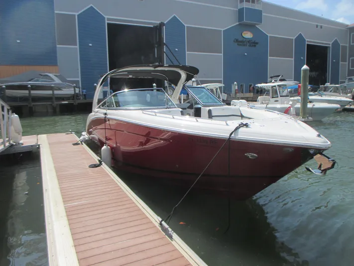  Yacht Photos Pics 2017 Regal 3200 Bowrider docked at marina, featuring sleek red design.