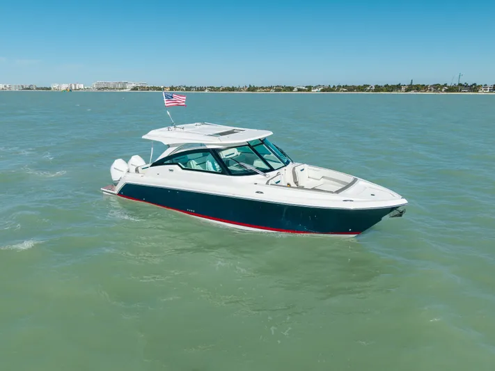  Yacht Photos Pics 2023 Tiara Yachts 34 LX on calm waters with American flag.