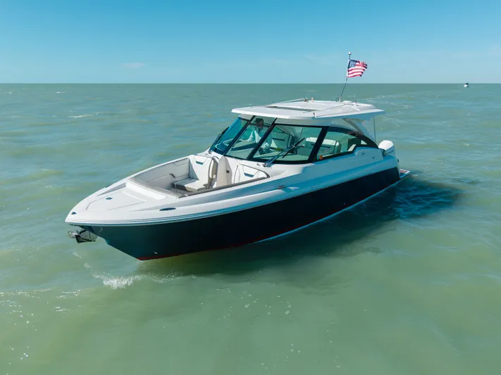  Yacht Photos Pics 2023 Tiara Yachts 34 LX on calm sea with American flag.