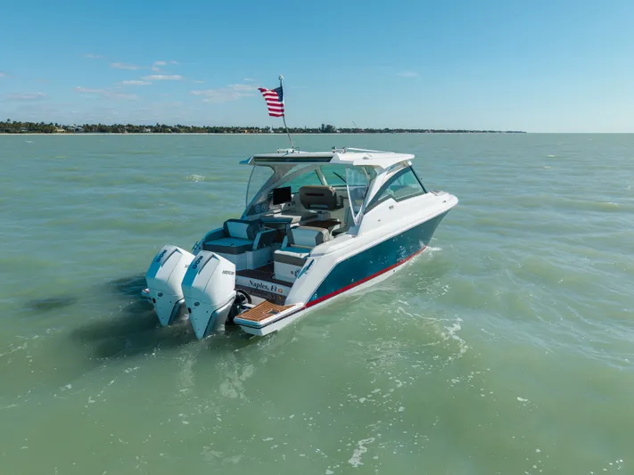  Yacht Photos Pics 2023 Tiara Yachts 34 LX on open water with American flag.