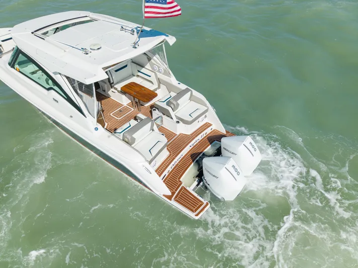  Yacht Photos Pics 2023 Tiara Yachts 34 LX on water with dual outboard engines.