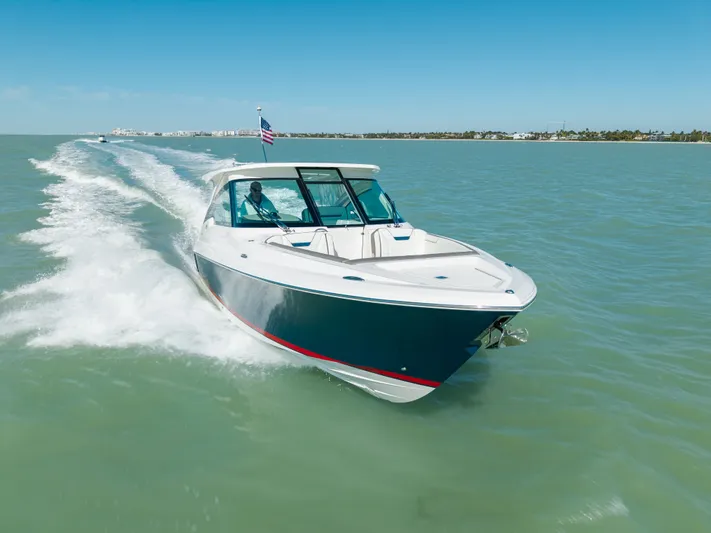  Yacht Photos Pics 2023 Tiara Yachts 34 LX cruising on open water, sunny day.