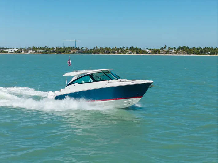  Yacht Photos Pics 2023 Tiara Yachts 34 LX cruising on water, sunny day.