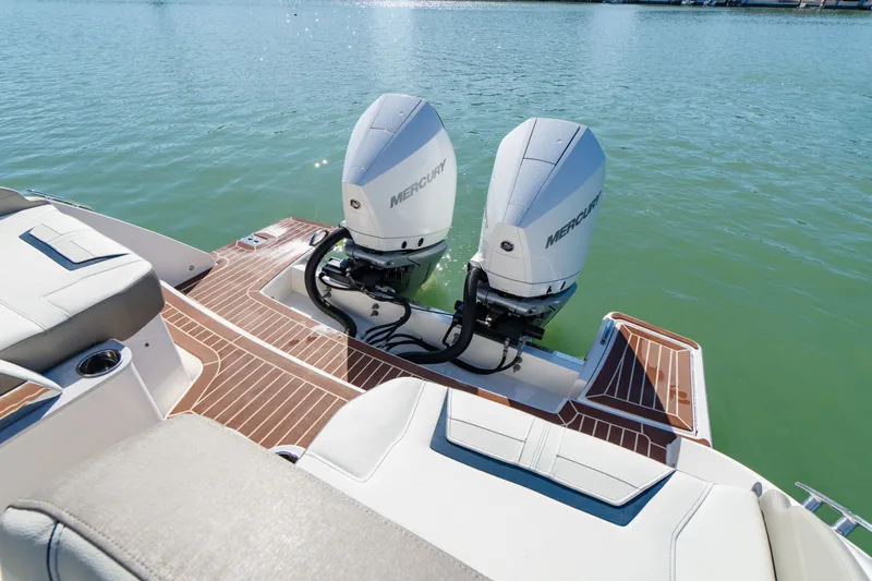  Yacht Photos Pics 2023 Tiara Yachts 34 LX with twin Mercury engines on calm water.