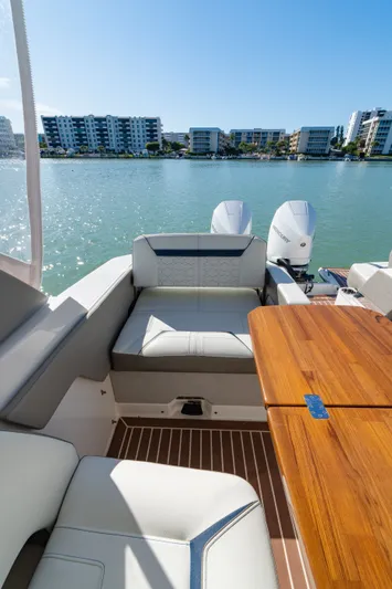  Yacht Photos Pics Interior of 2023 Tiara Yachts 34 LX with wooden table and seating area.