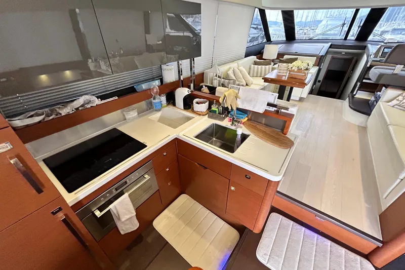  Yacht Photos Pics Luxurious interior of 2014 Prestige 550 Fly yacht with modern kitchen and seating area.