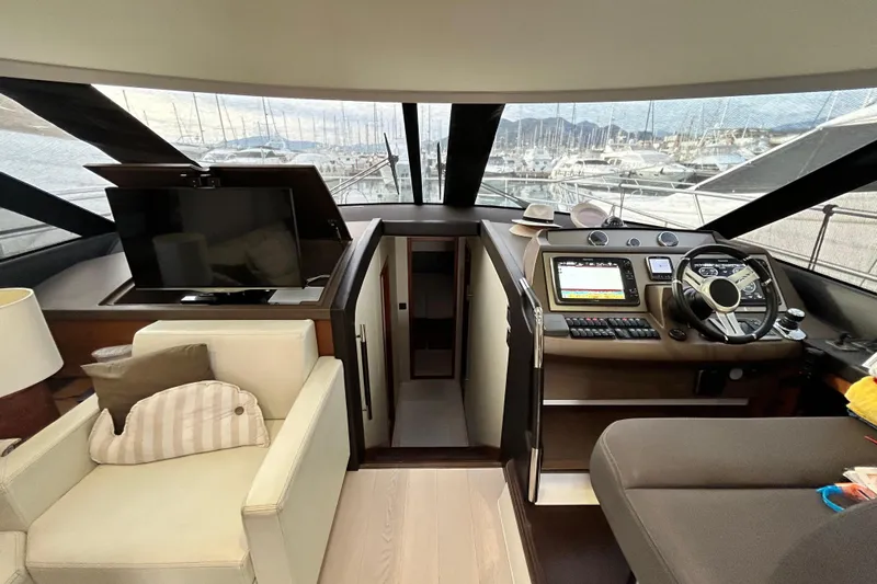  Yacht Photos Pics Luxurious interior of 2014 Prestige 550 Fly yacht with helm and seating area.