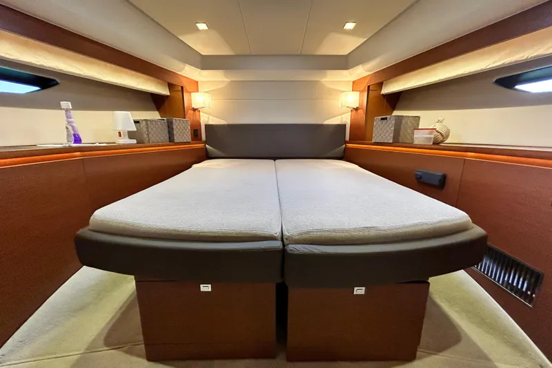  Yacht Photos Pics Luxurious interior cabin of 2014 Prestige 550 Fly yacht, featuring elegant bedding and ambient lighting.