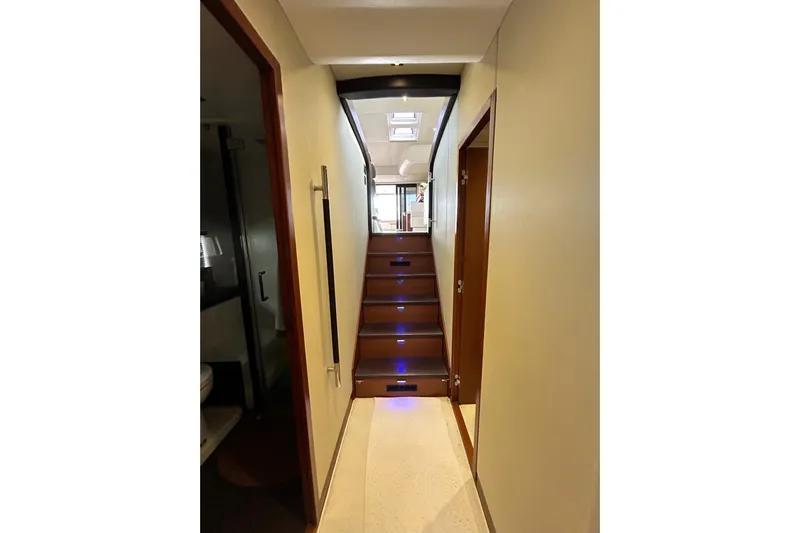  Yacht Photos Pics Interior hallway of 2014 Prestige 550 Fly yacht with illuminated stairs and modern design.