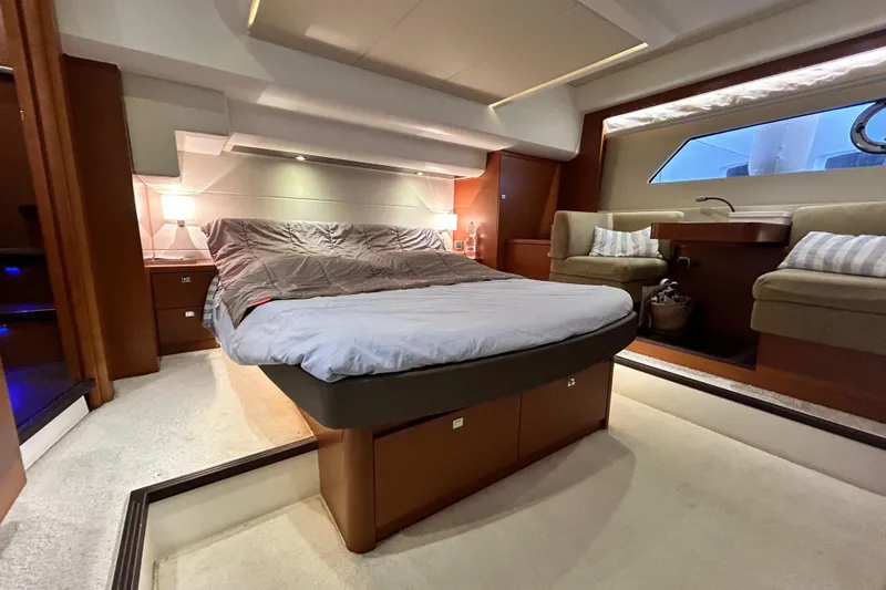  Yacht Photos Pics Luxurious interior of 2014 Prestige 550 Fly yacht with elegant bedroom and seating area.