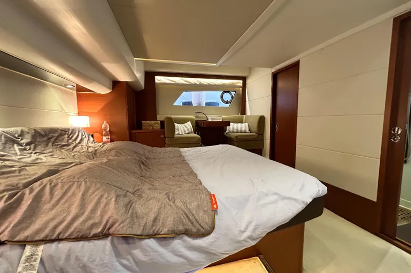  Yacht Photos Pics Luxurious bedroom interior of 2014 Prestige 550 Fly yacht with cozy bedding and seating area.