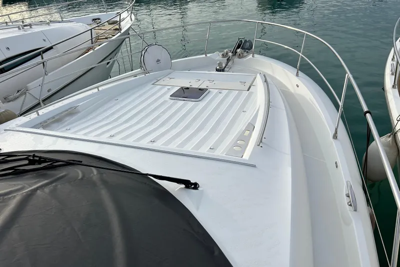  Yacht Photos Pics 2014 Prestige 550 Fly yacht deck, docked in marina, showcasing sleek design and spacious layout.