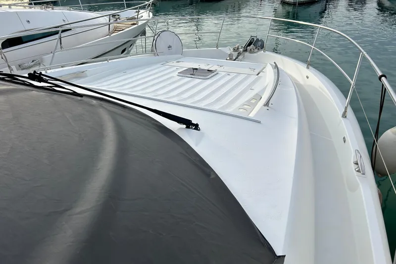  Yacht Photos Pics 2014 Prestige 550 Fly yacht deck with sleek design and railing, docked in marina.