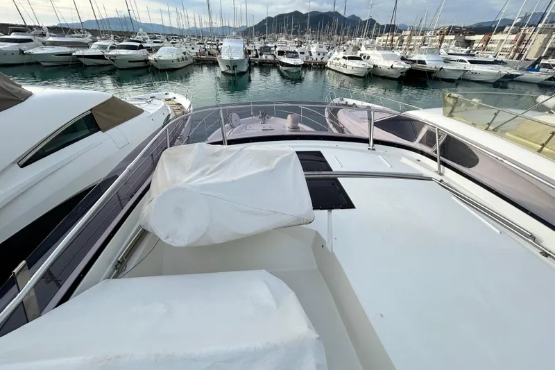  Yacht Photos Pics Prestige 550 Fly 2014 yacht docked in a marina with surrounding boats.