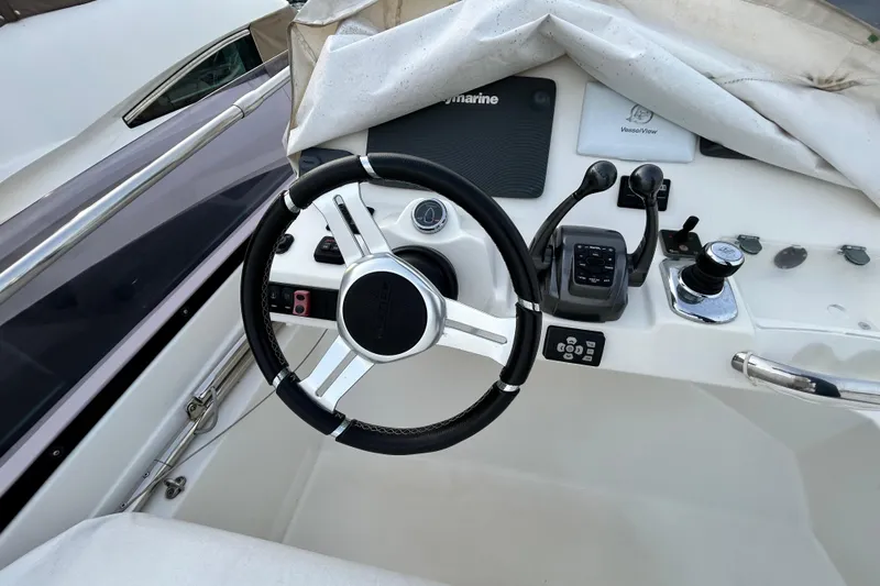  Yacht Photos Pics Steering console of 2014 Prestige 550 Fly yacht with controls and navigation equipment.