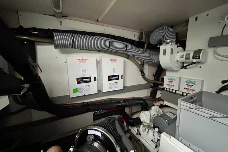  Yacht Photos Pics Engine room of a 2014 Prestige 550 Fly yacht with mechanical components and ventilation systems.