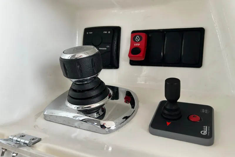  Yacht Photos Pics Control panel of a 2014 Prestige 550 Fly yacht with joystick and emergency stop button.