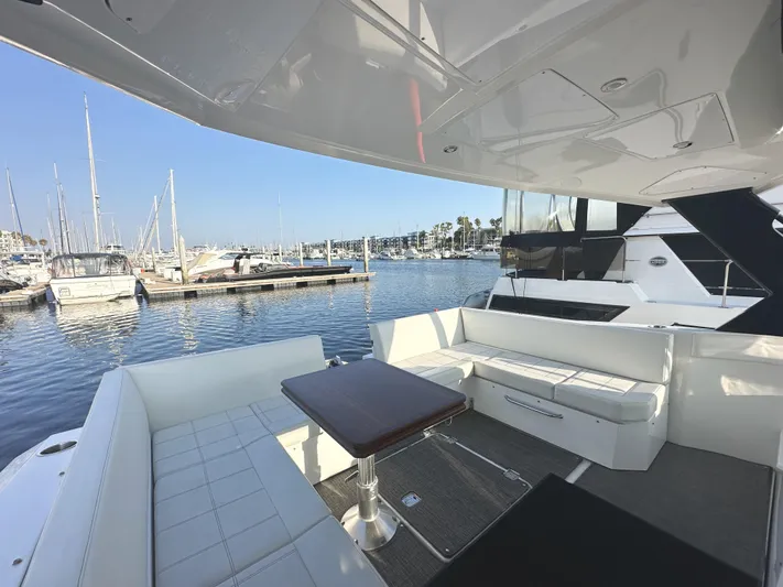 Lux Life Yacht Photos Pics 2017 Cruisers Yachts 390 Express Coupe, luxurious seating area, marina view.