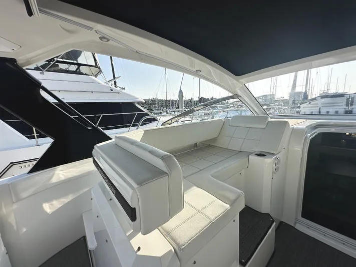 Lux Life Yacht Photos Pics 2017 Cruisers Yachts 390 Express Coupe interior with white seating, docked at marina.