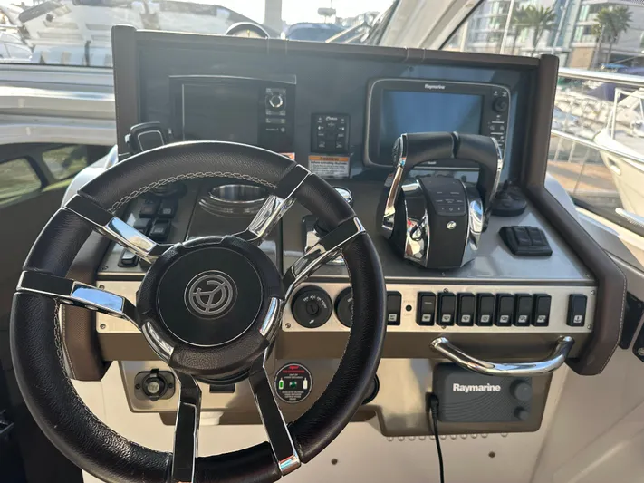 Lux Life Yacht Photos Pics Helm of 2017 Cruisers Yachts 390 Express Coupe with steering wheel and navigation controls.