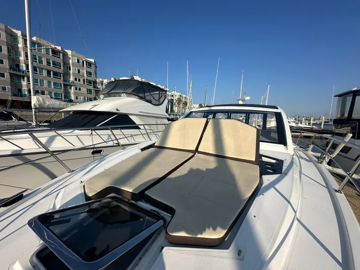 Lux Life Yacht Photos Pics 2017 Cruisers Yachts 390 Express Coupe with sunbathing deck, docked in marina.