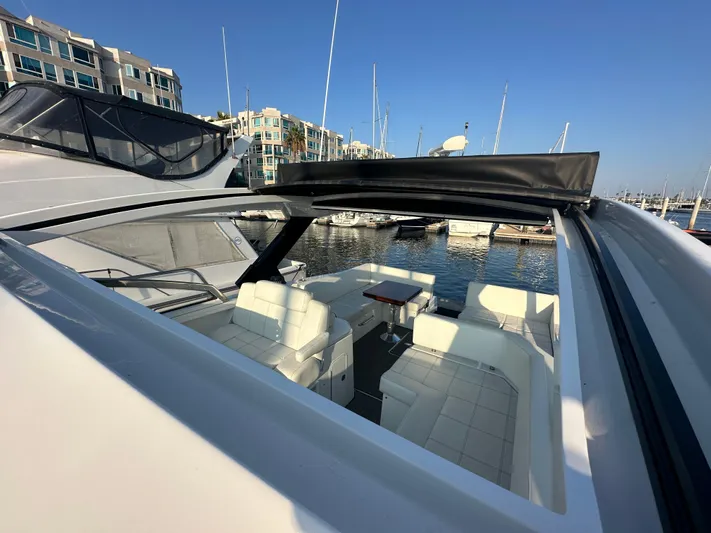 Lux Life Yacht Photos Pics 2017 Cruisers Yachts 390 Express Coupe at marina, featuring spacious seating and open roof.