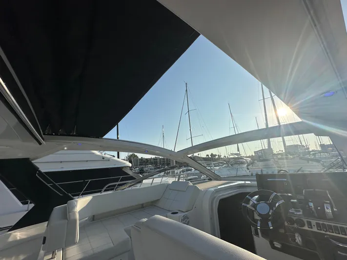 Lux Life Yacht Photos Pics 2017 Cruisers Yachts 390 Express Coupe interior with marina view at sunset.