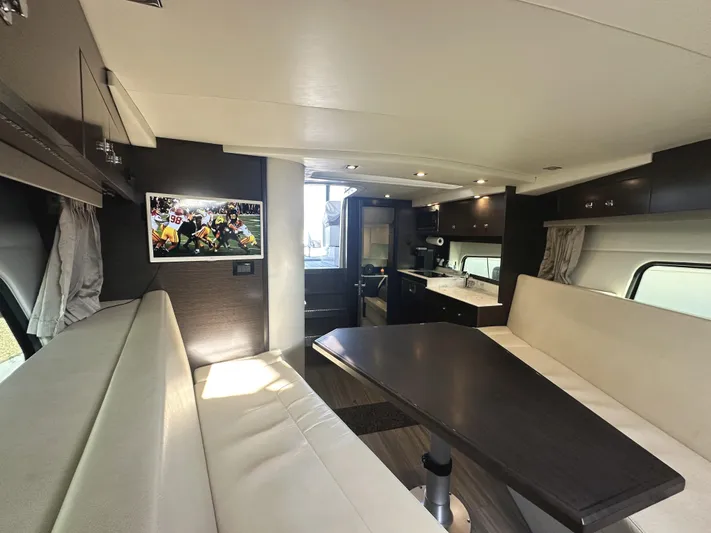 Lux Life Yacht Photos Pics Interior of 2017 Cruisers Yachts 390 Express Coupe with modern seating and dining area.