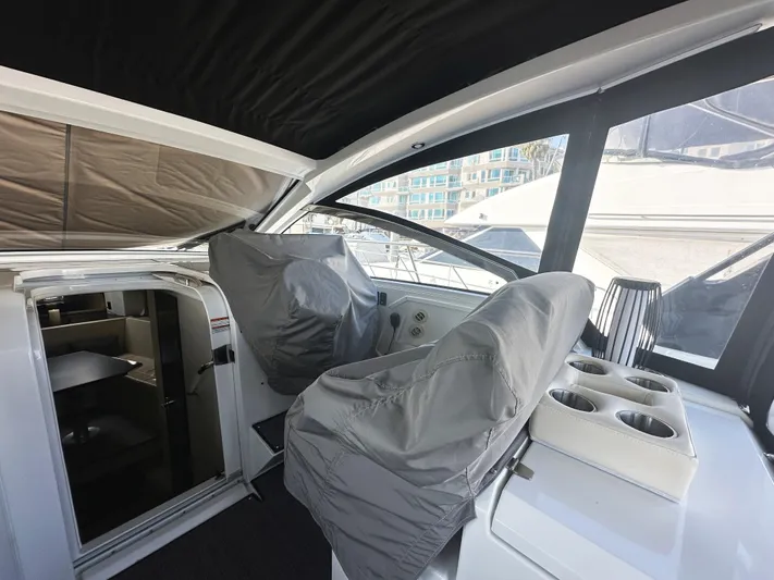 Lux Life Yacht Photos Pics 2017 Cruisers Yachts 390 Express Coupe interior with covered helm seats and cabin entrance.