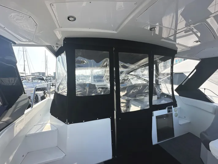 Lux Life Yacht Photos Pics 2017 Cruisers Yachts 390 Express Coupe interior with black canopy and marina view.