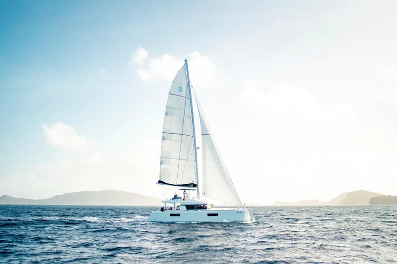  Yacht Photos Pics 2019 Lagoon 52 F sailing on open sea under clear sky.