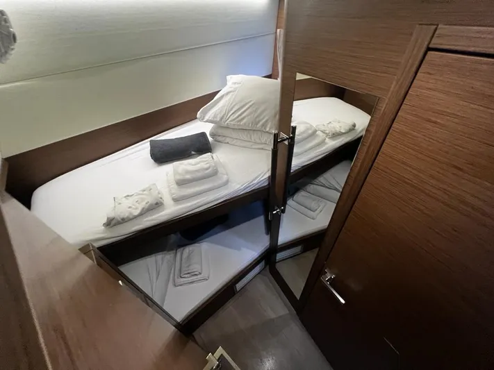  Yacht Photos Pics Cozy cabin interior of 2019 Lagoon 52 F yacht with neatly arranged bedding.