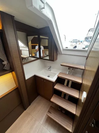  Yacht Photos Pics Interior of 2019 Lagoon 52 F yacht with modern wooden stairs and sleek design.