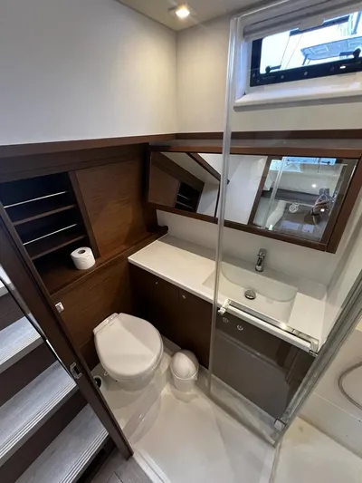  Yacht Photos Pics 2019 Lagoon 52 F yacht bathroom with modern fixtures and wooden accents.