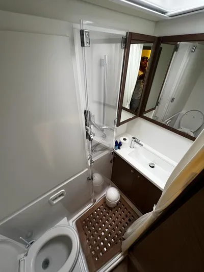  Yacht Photos Pics Bathroom interior of 2019 Lagoon 52 F yacht with modern fixtures and wooden accents.