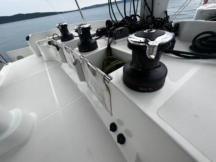  Yacht Photos Pics 2019 Lagoon 52 F yacht deck with winches and ropes, overlooking calm waters.