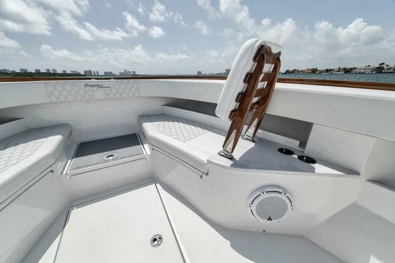 Sapelo Yacht Photos Pics 2024 Front Runner 47 Center Console boat interior with seating and speaker, under clear skies.