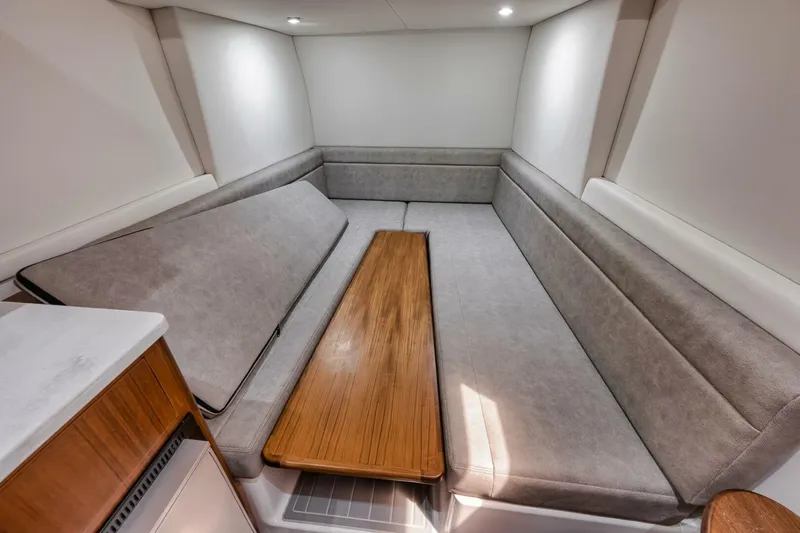 Sapelo Yacht Photos Pics 2024 Front Runner 47 Center Console cabin interior with seating and wooden table.