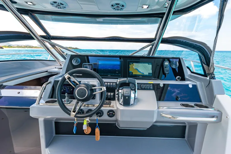  Yacht Photos Pics 2025 Jeanneau Cap Camarat 12.5 WA helm with advanced navigation systems and ocean view.